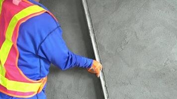 Close up hand worker uses tools to smooth plaster on a wall Home construction and home decoration archive in architecture video