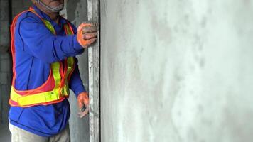 Close up hand worker uses tools to smooth plaster on a wall Home construction and home decoration archive in architecture video