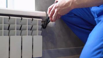 Close-up Of Male Plumber Fixing Heating Radiator Using Wrench At Home video