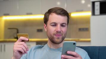 A man using credit card to make online payment on smartphone. Caucasian man using cellphone for shopping online. Guy using smart phone to check credit card transactions from app video
