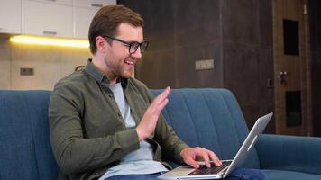 Businessman talking to colleague team in call conference writing note on book with smile face. Man using computer laptop for online meeting. Smart working from home concept video