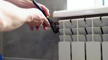 Close-up Of Male Plumber Fixing Heating Radiator Using Wrench At Home video