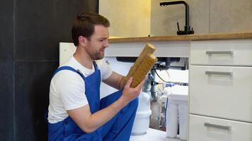 Plumber working replaceable dirty used aqua filter for filtration of reverse osmosis water video
