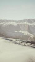 snowy mountains with deep ravine and rock cliffs video