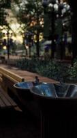 closeup of a drinking water fountain in a park on sunset video