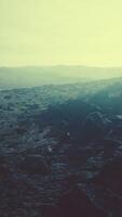 Snow covered rocky hill in middle of desert on cloudy day video