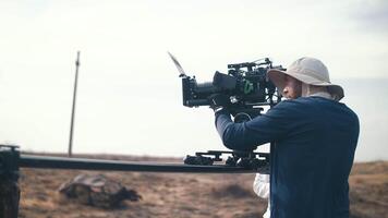 Filming in the steppe. The operator moves the camera along the slider video