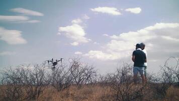 Drone with a camera in the air on the set of a movie. Drone landing after shooting. Filming in the desert video