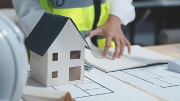 A foreman sits at a desk in an office, Calculating costs, Planning construction, Calculating structures, Planning and calculating project construction costs, Project presentation plan. video