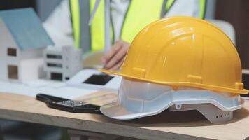 A foreman sits at a desk in an office, Calculating costs, Planning construction, Calculating structures, Planning and calculating project construction costs, Project presentation plan. video