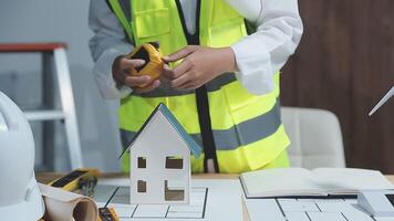 A foreman sits at a desk in an office, Calculating costs, Planning construction, Calculating structures, Planning and calculating project construction costs, Project presentation plan. video