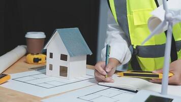 A foreman sits at a desk in an office, Calculating costs, Planning construction, Calculating structures, Planning and calculating project construction costs, Project presentation plan. video