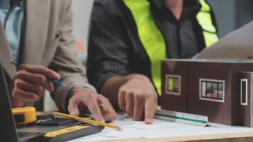 Teamwork men in construction site, Two civil engineer or professional foreman in safety helmet hard hat using blueprint in digital tablet working while standing at industrial factory, teamwork concept video