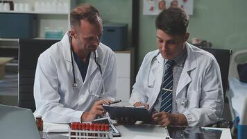 Doctors in office working on medical report video