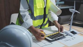 A foreman sits at a desk in an office, Calculating costs, Planning construction, Calculating structures, Planning and calculating project construction costs, Project presentation plan. video