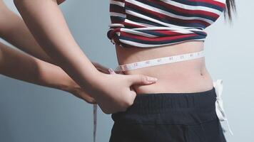 fat woman, fat belly, chubby, obese woman hand holding excessive belly fat with measure tape, woman diet lifestyle concept video