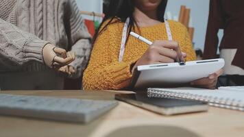 de designer är arbetssätt och väljer färger för de Kläder design i en Bra humör leende med lycka på skapande de arbete video