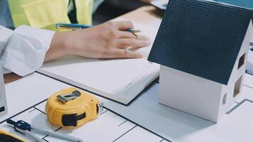 Architect working on blueprint.engineer inspective in workplace - architectural project, blueprints,ruler,calculator,laptop and divider compass. Construction concept. Engineering tools, video