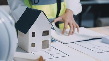 Architect working on blueprint.engineer inspective in workplace - architectural project, blueprints,ruler,calculator,laptop and divider compass. Construction concept. Engineering tools, video