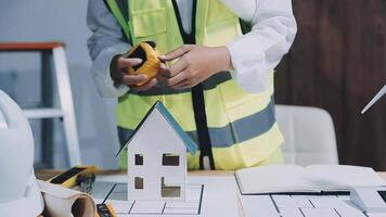 Architect working on blueprint.engineer inspective in workplace - architectural project, blueprints,ruler,calculator,laptop and divider compass. Construction concept. Engineering tools, video
