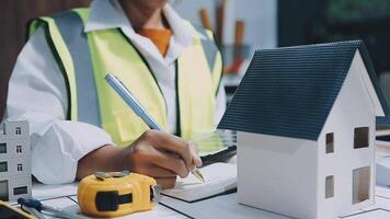 Architect working on blueprint.engineer inspective in workplace - architectural project, blueprints,ruler,calculator,laptop and divider compass. Construction concept. Engineering tools, video