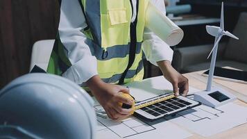Architect working on blueprint.engineer inspective in workplace - architectural project, blueprints,ruler,calculator,laptop and divider compass. Construction concept. Engineering tools, video