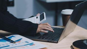 Asian accountant working and analyzing financial reports project accounting with chart graph in modern office, finance and business concept. video