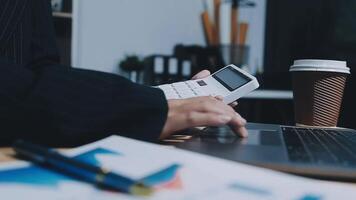 Asian accountant working and analyzing financial reports project accounting with chart graph in modern office, finance and business concept. video