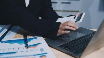 Asian accountant working and analyzing financial reports project accounting with chart graph in modern office, finance and business concept. video