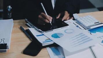 Asian accountant working and analyzing financial reports project accounting with chart graph in modern office, finance and business concept. video