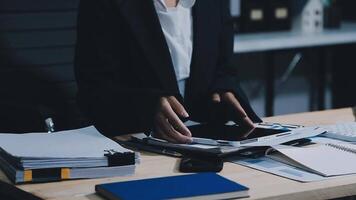 Asian accountant working and analyzing financial reports project accounting with chart graph in modern office, finance and business concept. video