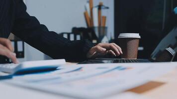 Asian accountant working and analyzing financial reports project accounting with chart graph in modern office, finance and business concept. video