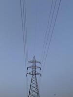 Transmission Lines and tower for transmitting electricity in Lahore, Pakistan on June 4, 2024. photo