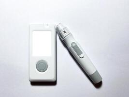 Measurement of blood sugar levels using a glucose meter with a mock-up. Piercing a finger to draw blood photo