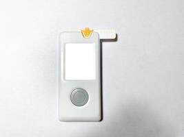 Measurement of blood sugar levels using a glucose meter with a mock-up. Piercing a finger to draw blood photo