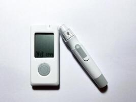 Measurement of blood sugar levels using a glucose meter with a mock-up. Piercing a finger to draw blood photo