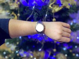 A view of the quartz watch dial with a stainless steel strap on the arm with a mockup photo