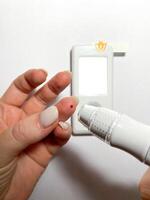 Measurement of blood sugar levels using a glucose meter with a mock-up. Piercing a finger to draw blood photo
