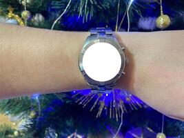 A view of the quartz watch dial with a stainless steel strap on the arm with a mockup photo