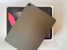 The tablet is black on a white isolated background with a mock up. Back side view of the tablet photo
