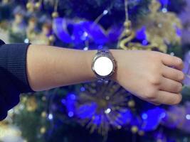 A view of the quartz watch dial with a stainless steel strap on the arm with a mockup photo