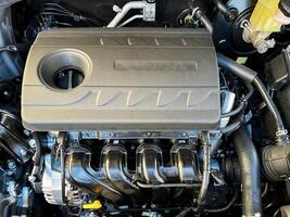 The engine compartment of the car, a view of the engine. Four-cylinder engine photo