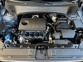 The engine compartment of the car, a view of the engine. Four-cylinder engine photo