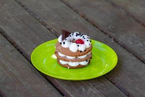 A cake or Honey cake close-up, standing on a wooden table photo