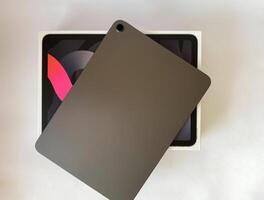 The tablet is black on a white isolated background with a mock up. Back side view of the tablet photo