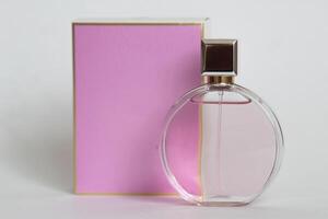 Perfume bottle from a pink box on an isolated background with mockup and copyspace photo