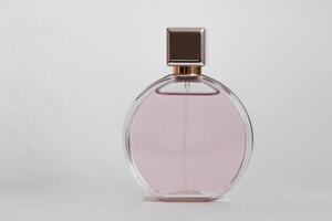 Perfume bottle from a pink box on an isolated background with mockup and copyspace photo