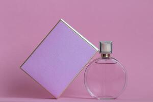 Perfume bottle from a pink box on an isolated background with mockup and copyspace photo