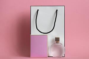 Perfume bottle from a pink box on an isolated background with mockup and copyspace photo
