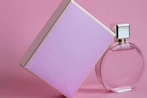 Perfume bottle from a pink box on an isolated background with mockup and copyspace photo